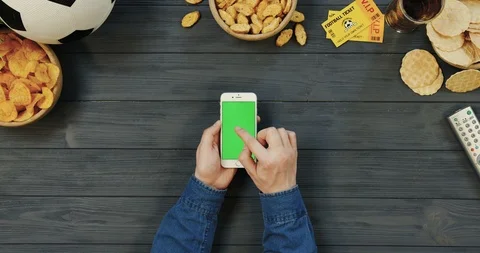 View from above on the white vertical smartphone on the dark grey wooden table Stock-Footage 96438458
