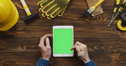 View from above on the white vertical tablet device on the wooden desk of Stock-Footage 96182513