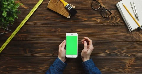 View from above on the white vertically smartphone on the wooden desk with Stock-Footage 96176631