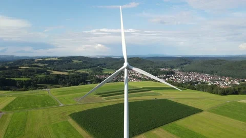 View from above of a white wind turbine that is slowly turning the rotor Stock Footage 164422657