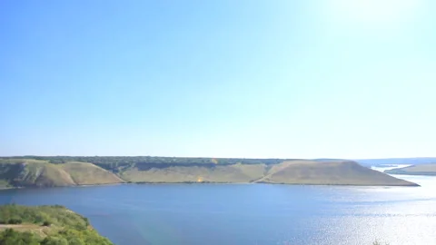 View from above on a wide river with steep banks and islands at dawn on a misty Stock Footage 94228211