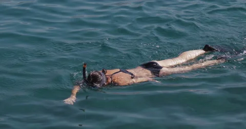 A view from above of a woman diving on the surface of the water. Stock Footage 139907458
