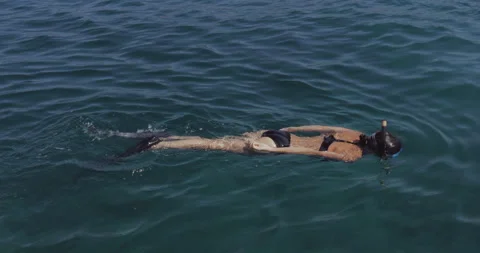 A view from above of a woman diving on the surface of the water. Stock Footage 139907910