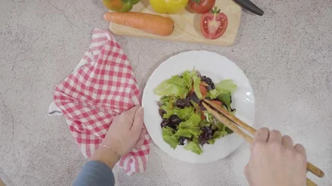 View from above of Woman's hands picking up delicious fresh salad Stock Footage 240330825