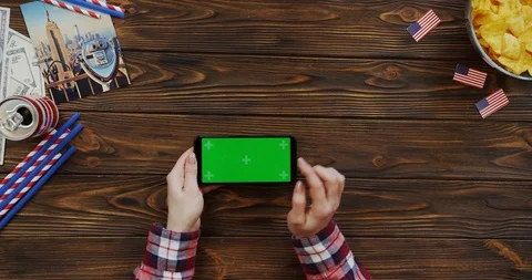 View from above on the woman's hands scrolling and taping on the black Stock Footage 91726419