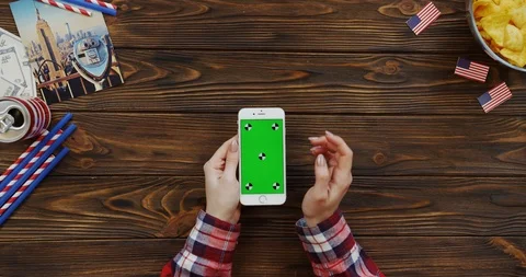 View from above on the woman's hands scrolling and taping on the white vertical Video stock 91732065