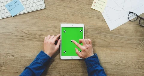 View from above on the woman's hands using the white tablet device with a green Stock-Footage 89979022