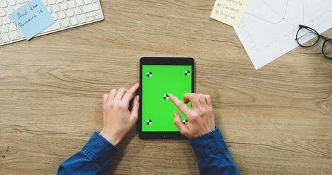 View from above on the woman's hands using the black tablet device with a green Stock Footage 89979436