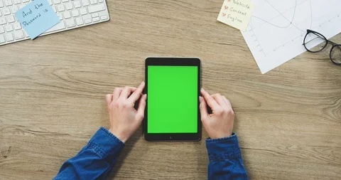 View from above on the woman's hands using the black tablet device with a green Stock-Footage 89979797