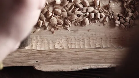 View from above. wood carver processes a oak wood board with a chisel. woodwo Stock Footage 166082154