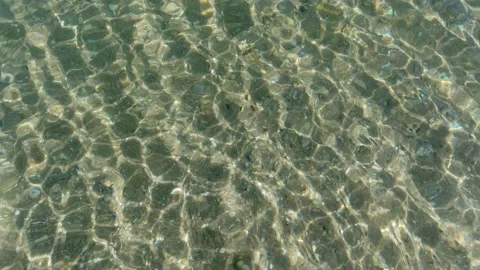 View from above of yellow sand on the seabed through transparent clear water Stock Footage 136098279