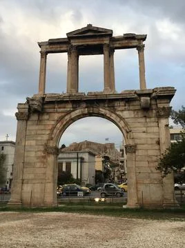 View of acropolis of Athens through ancient ruins of city gate Stock Photos
