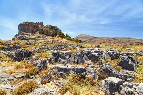 View of the Acropolis  Lindos from rocks below. Rhodes Greece Stock Photos