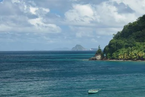 View across the bay to a string of small Caribbean Islands, rowing boat in fo Stock Photos