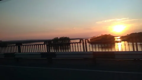 View across the bridge towards the setting sun. Side view. Stock Footage 134977165