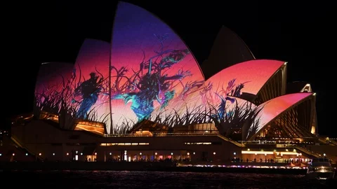 View across Circular Quay to Sydney Opera House lit up with light display Stock Footage 128400754