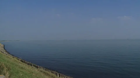 View across the estuary of the Eastern Scheldt + pan left Plompe Toren Stock Footage 33153998