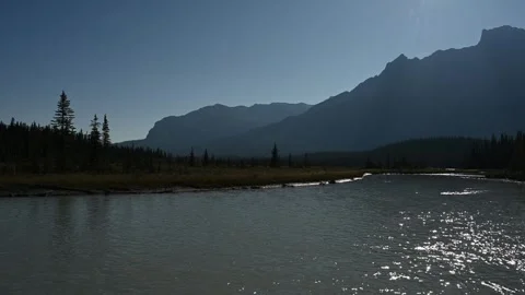 View Across a Fast Flowing Northern Park River with Blue Mountains and Clear Stock Footage 331683940
