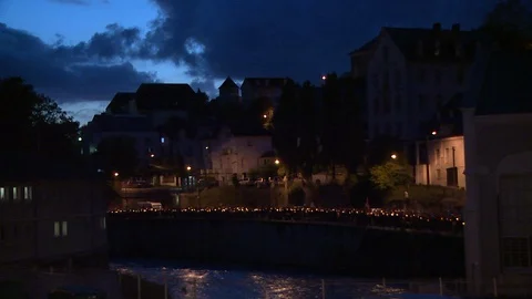 View across river of candlelight Marian procession in Lourdes, France Stock Footage 86758463