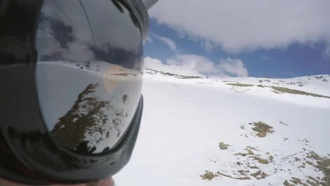 View from action camera aimed at mask of snowboarder riding on ski elevator Stock Footage 133502702