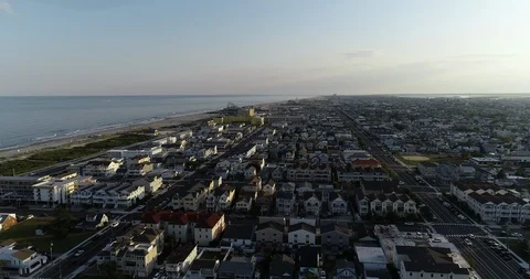 View from aerial drone flying over New Jersey beach town in evening time around Stock Footage 116338920