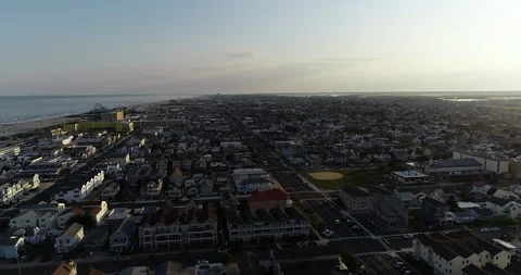 View from aerial drone flying over New Jersey beach town in evening time around Stock Footage 116339315
