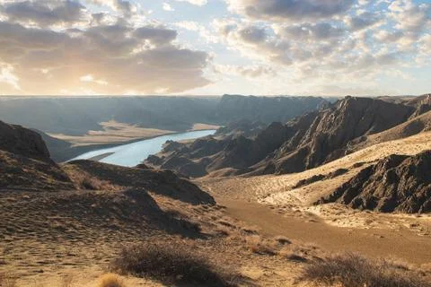 View from afar of the river in the arid steppe of Kazakhstan Ili, Almaty region Stock Photos