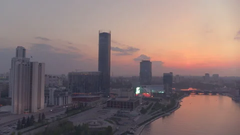 View from the air at a beautiful pink sunset over the river in the city centre Stock Footage 135700726