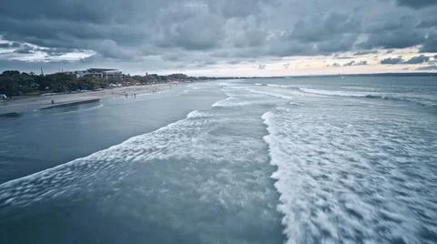View from the air of the waves gently lapping the shore in the evening Stock Photos