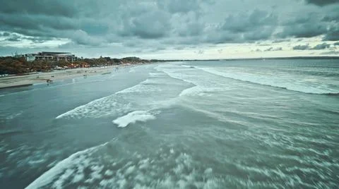 View from the air of the waves gently lapping the shore in the evening Stock Photos