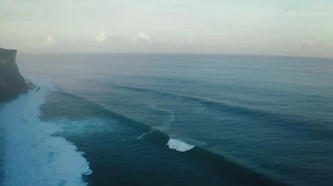 View from the air of the waves gently lapping the shore in the evening Stock Photos