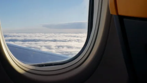 View from the aircraft window on the clouds lit by sunlight Stock Footage 126824277