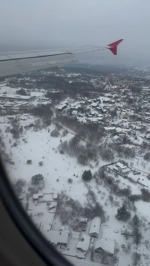 View from airplane approaching Vilnius in snowy winter day. Vertical Stock Footage 262365305