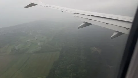 View from airplane during landing in Pisa with visible coastline on rainy day Stock Footage 306959812