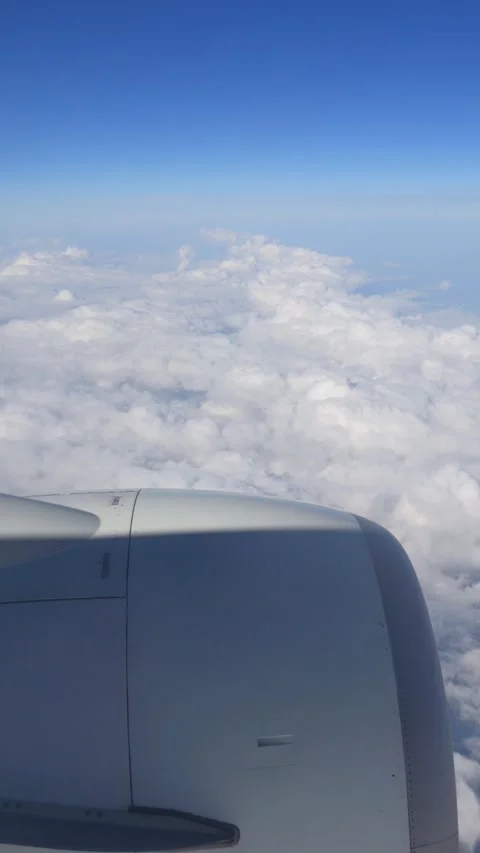 View of an airplane engine against a vast sky and clouds below in 4K vertic.. Stock Footage 294342545