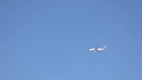 View of airplane flying in blue sky. Taken from hands Stock Footage 304886618