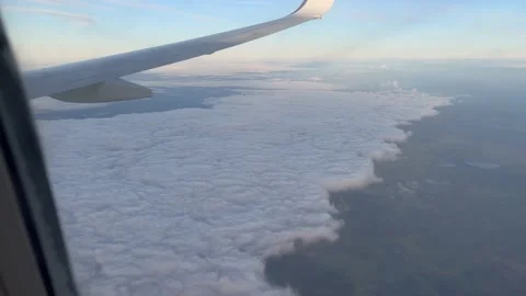 View from airplane flying over layer of white clouds Stock Footage 195470363