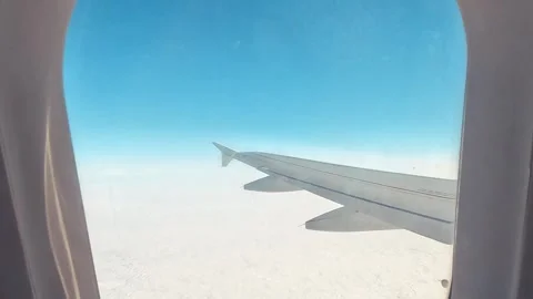 View Of Airplane Passenger Window And Wings In The Sky 動画素材 339977028