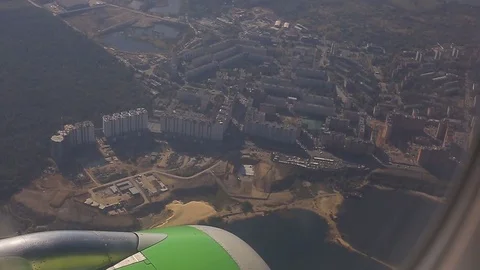 A view from the airplane, the plane is flying over the city Stock Footage 73983239