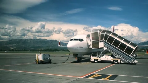 View of an airplane with plane ramp standing at the airport against the backdrop Stock Footage 162420004