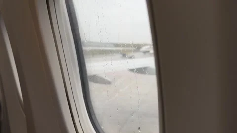 View from airplane staying on runway on rainy day Stock Footage 255901627