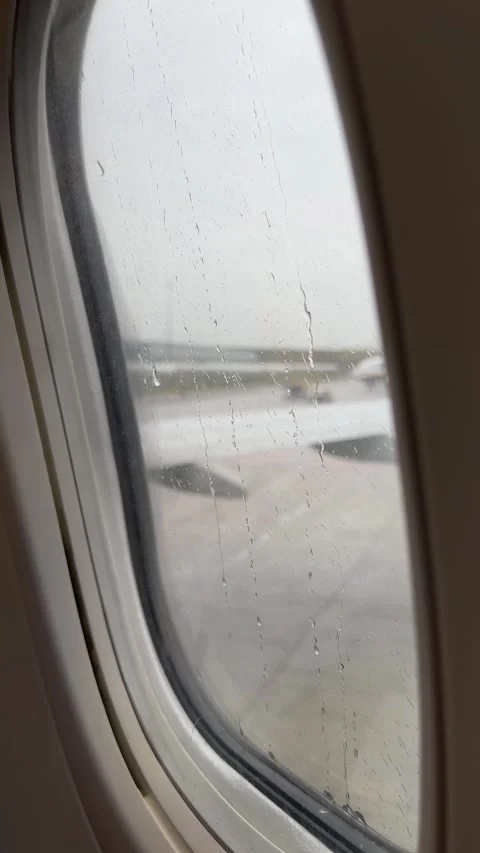 View from airplane staying on runway on rainy day. Vertical video Stock Footage 255901628