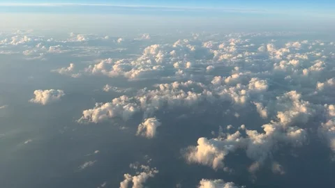 View from Airplane Window Above Beautiful Clouds. Sunset Warm Light. United.. Stock Footage 339295573