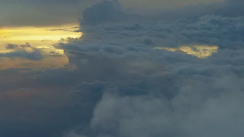 View from airplane window above clouds during colorful sunset sky Stock-Footage 330963675