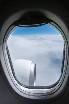 View from airplane window above the clouds with aircraft engine visible Stock Photos