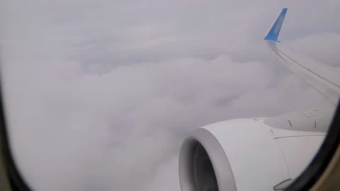 View from the airplane window on the beautiful fluffy clouds. Stock Footage 130473211