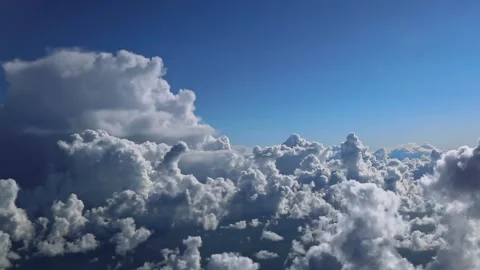 View from the airplane window to the blue sky and white cloud Stock Footage 202516238