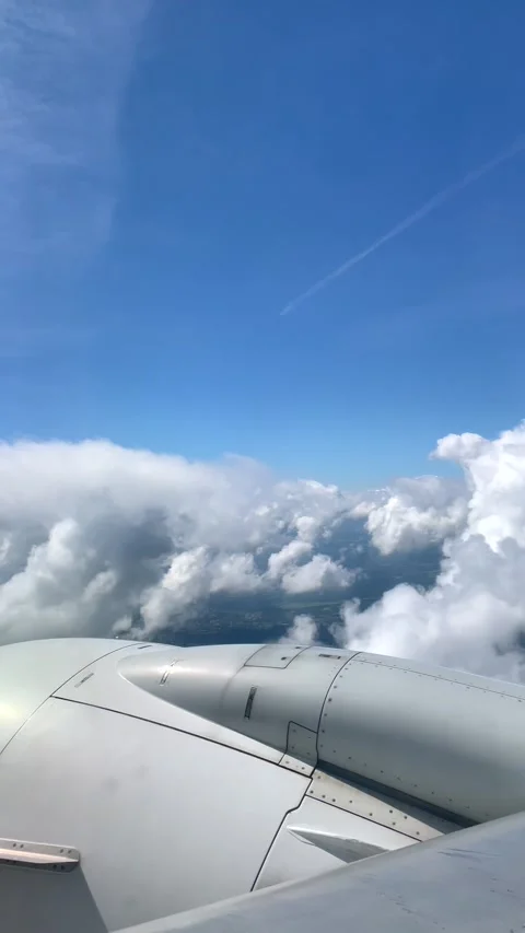 View from the airplane window to blue sky and white clouds. Stock Footage 278310906