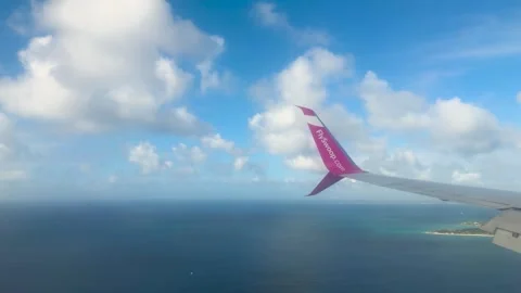 View from an airplane window of a blue sky with clouds. 動画素材 327359023