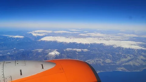 View from the airplane window of a bright orange turbine flying Stock Footage 126613012